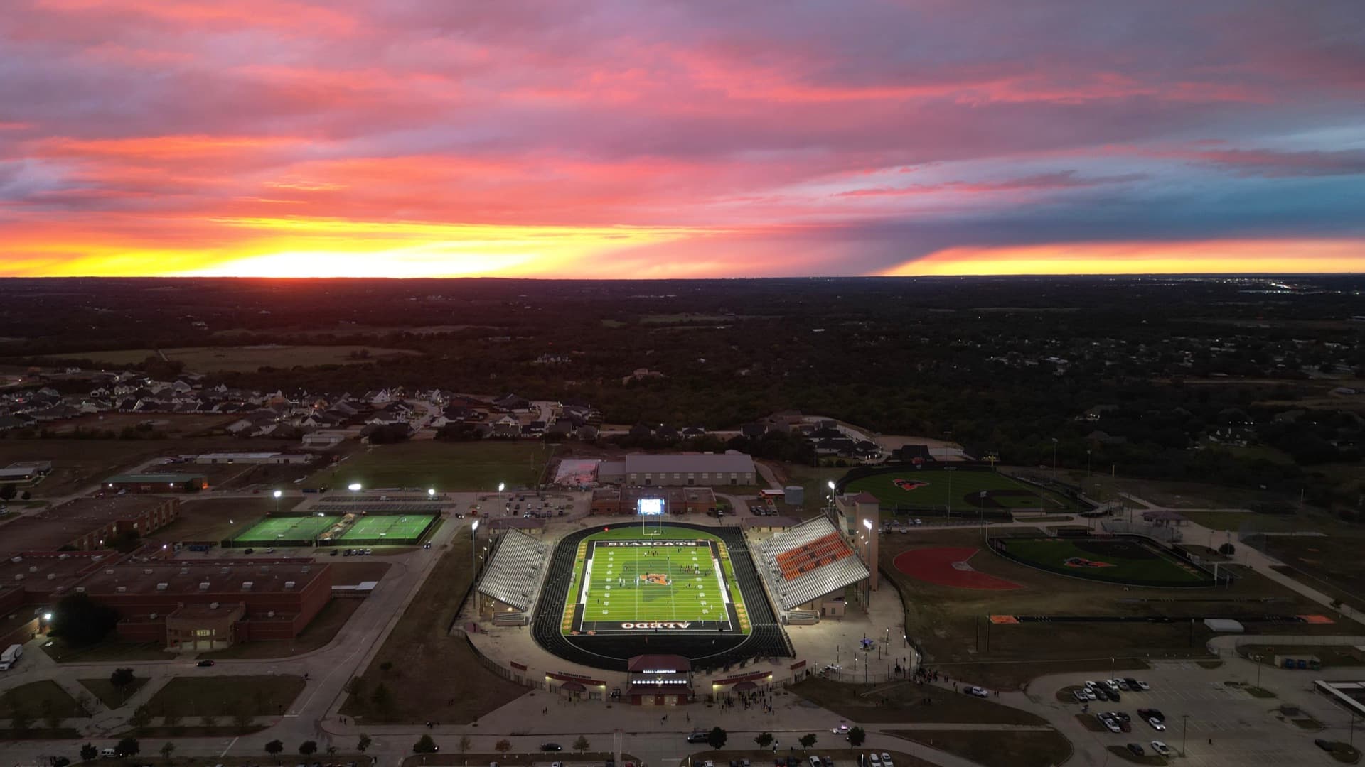 Aerial drone photo of Aledo stadium at sunset