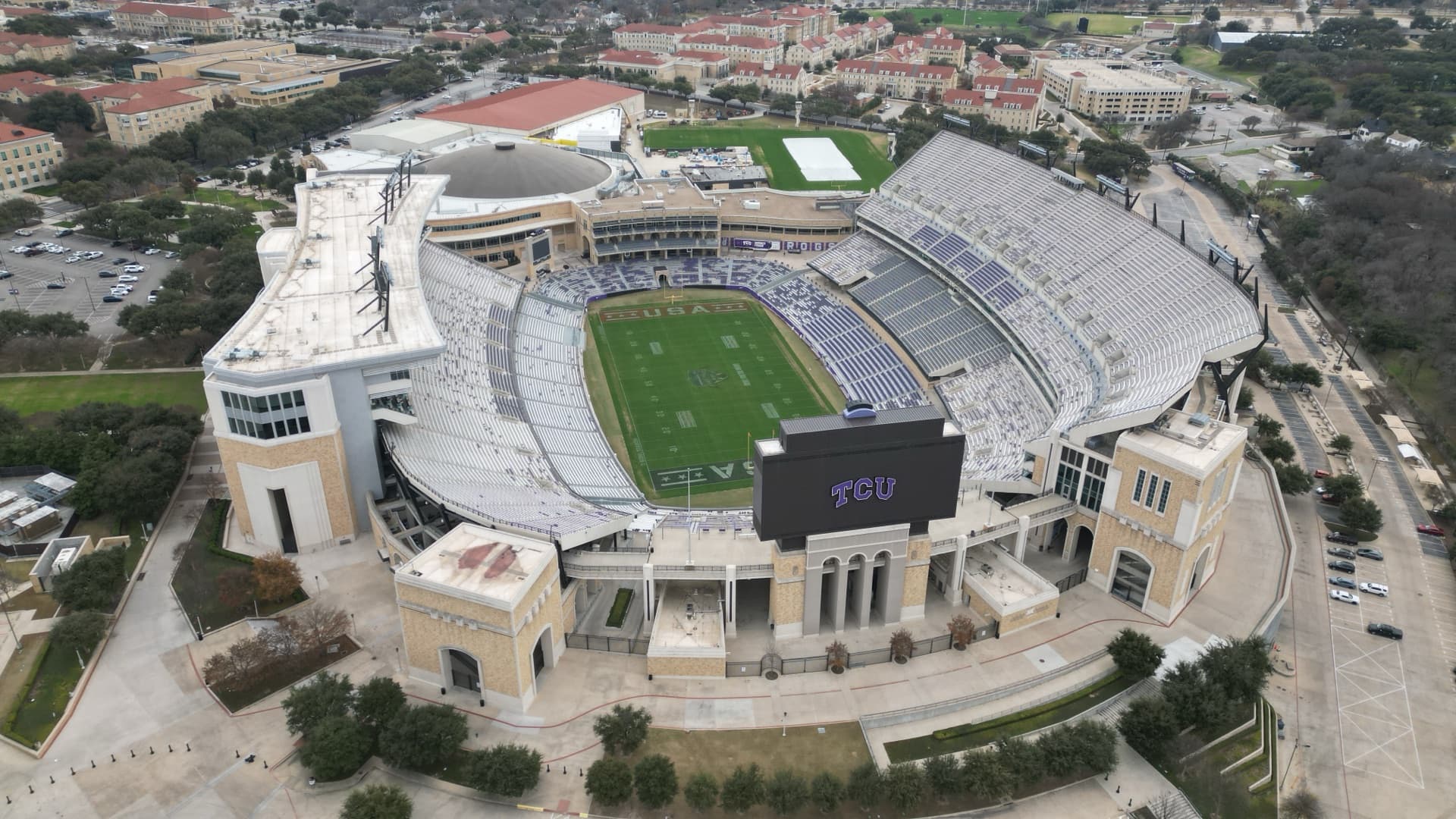 Aerial drone photo of Amon G. Carter Stadium at TCU in Fort Worth showing full bowl, field, and surrounding campus
