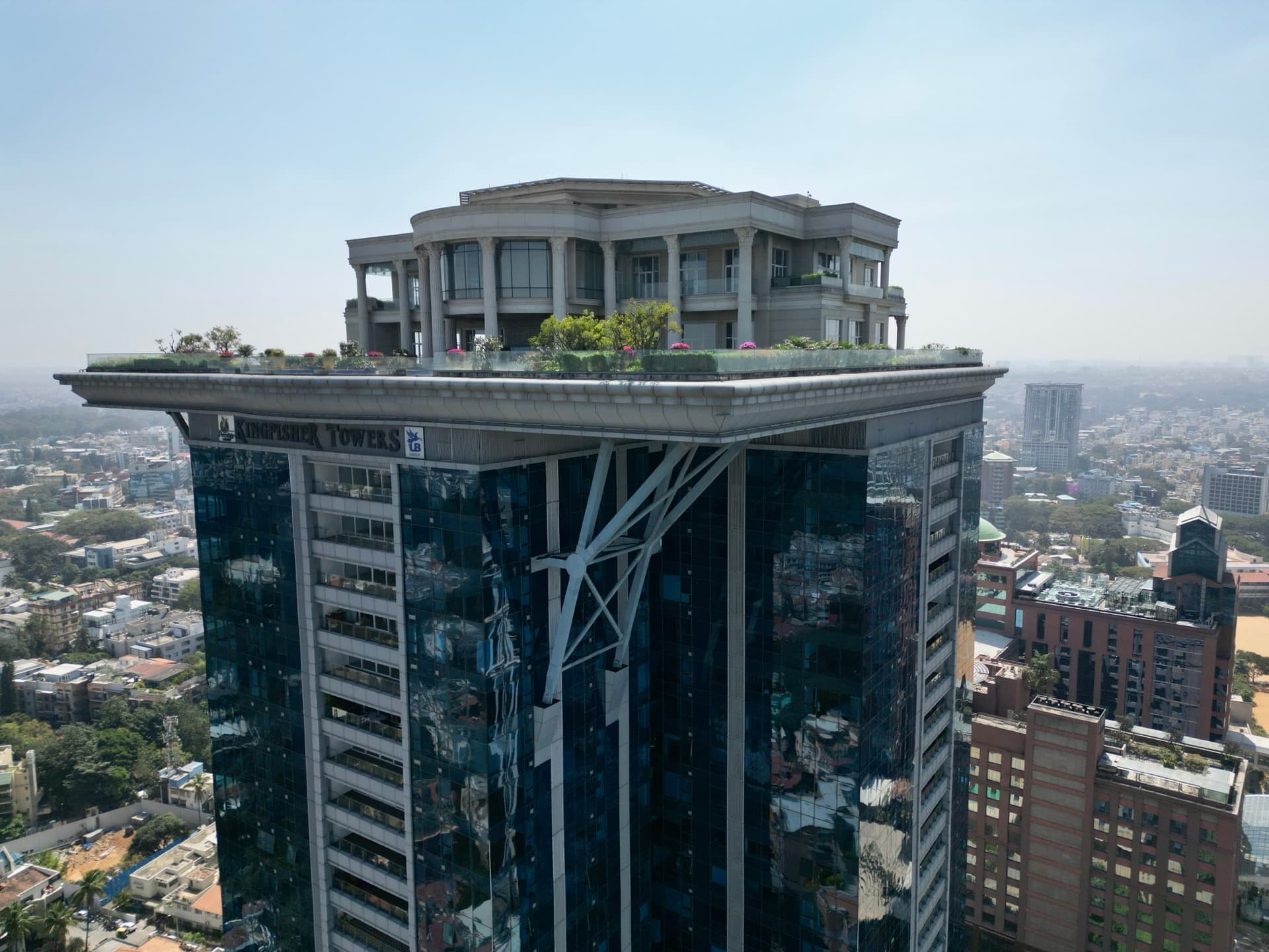Aerial drone photo of Kingfisher Towers rooftop penthouse and infinity garden rising above a city skyline